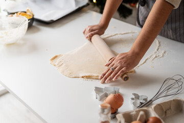 Smiling woman in the kitchen baking christmas cookies