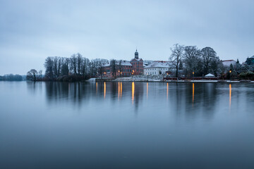 Castle of Eutin on winter day with reflections on water, Schleswig-Holstein, Germany