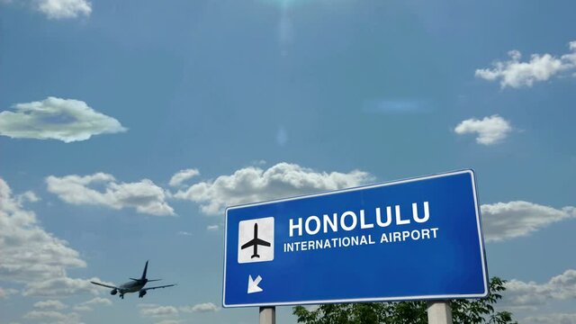 Jet plane landing in Honolulu, Hawaii, USA. City arrival with airport direction sign. Travel, business, tourism and airplane transport concept.