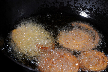 Homemade Preparation of Indian Traditional Snack Chakli consumed during diwali festival, a spiral shaped crisp deep fried snack, It is known as Chakali, Murkoo, Muruku and Murukku.