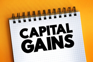 Capital Gains text on notepad, concept background.