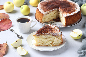 Charlotte with apples and a cup of coffee on a light background.