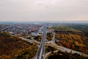 Aerial view of a road system passing among autumn city landscape. Wallpaper Earth environment