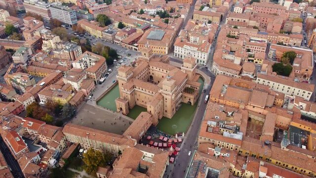 Aerial drone footage of the famous medieval castle in Ferrara old town in Italy. Shot with a tilt down and motion. 