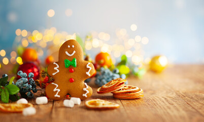 Christmas gingerbread cookies with Christmas decorations on wooden background.
