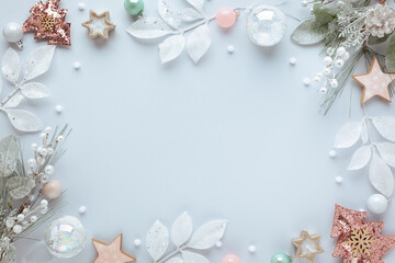 Christmas and New Year holidays frame. Christmas ornaments on light pastel background. Flat lay, copy space.