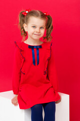 Cute blue eyed girl staring at camera in studio