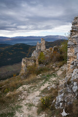Partial view of ruins of medieval castle in Rocca Calascio and autumn mountains of Abruzzo, Italy