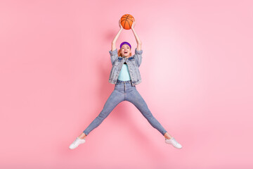 Full body photo of funny blond young lady play basketball wear jeans jacket visor isolated on pink background