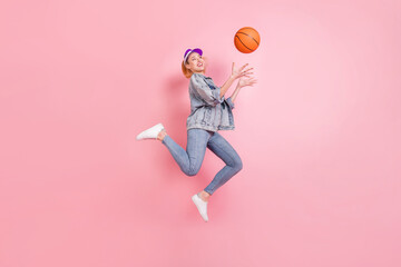 Fototapeta na wymiar Full length profile photo of cool sporty lady catch ball jump wear jeans shirt cap isolated on pink background