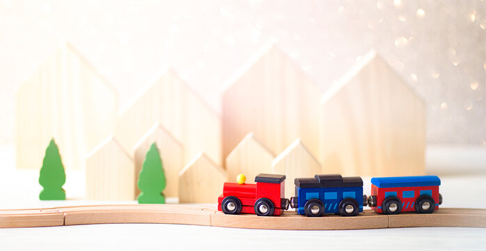 Miniature Figure Toy Wooden Train, Christmas tree and wooden houses on wooden background, Image for Christmas Holiday decorative concept.