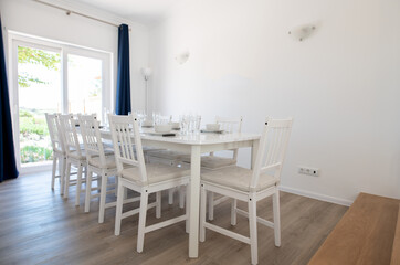 Contemporary dining room with white walls and white table and chairs