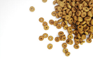 dry pet food scattered - top view, space for text. flat lei wet cat food on a white background.