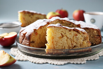 Homemade pie Charlotte with apples on blue background.