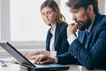 colleagues in the office in front of a laptop career work technologies