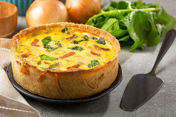 Spinach quiche with onion and bacon.