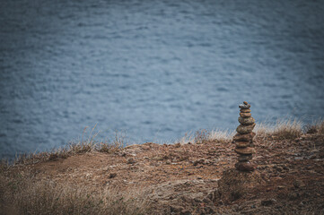 Fototapeta na wymiar Stone tower on the rocky beach of Madeira