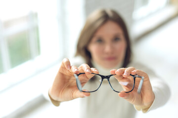 Woman with glasses. Beautiful girl wears glasses for vision. High quality photo