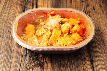 Chicken jalfrezi dish in a plastic bowl