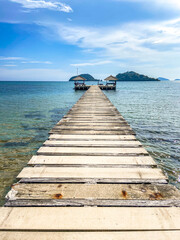 Fototapeta premium Koh Mak tropical island and its long wooden pier on the sea, near koh Chang, Trat, Thailand