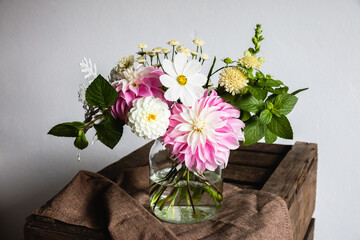 Bouquet of summer flowers in a vase on a wooden table - 466900694