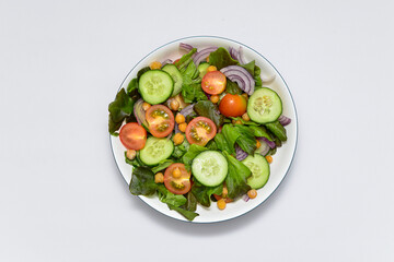 vegetable salad with olive oil on the white background. horizontal view. Free space for menu. Vegetarian diet.