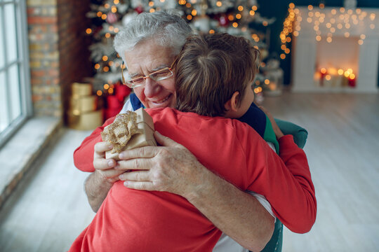 Children give grandfathers a present for Christmas. High quality photo