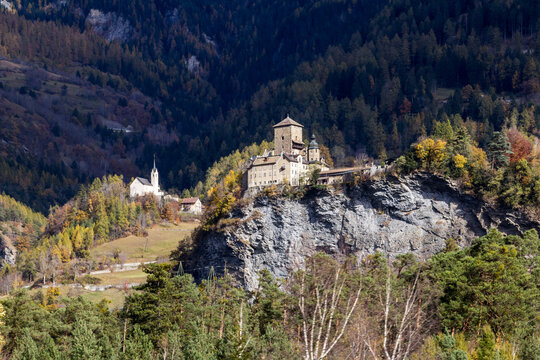 Ortenstein Castle (built in 1250) and the Cathlic church Tomlis near the Swiss village Domleschg in Canton Graubuenden, Switzerland