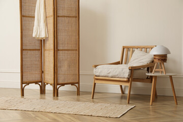 Stylish room with folding screen and armchair. Interior design