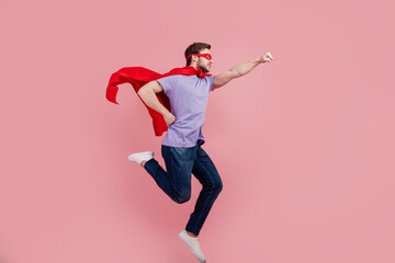 Full size profile side photo of young superman strong power safety run help isolated over pink...