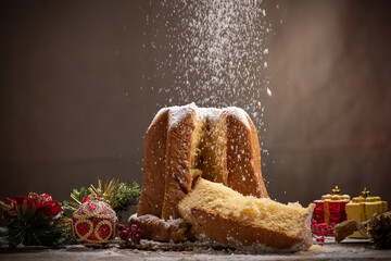 Traditional Italian Christmas cake Pandoro with christmas decoration and gifts.