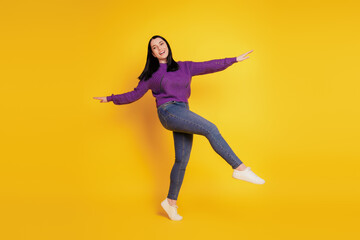 Fototapeta na wymiar Full length body size view of nice attractive cheerful playful girl having fun fooling isolated on yellow color background