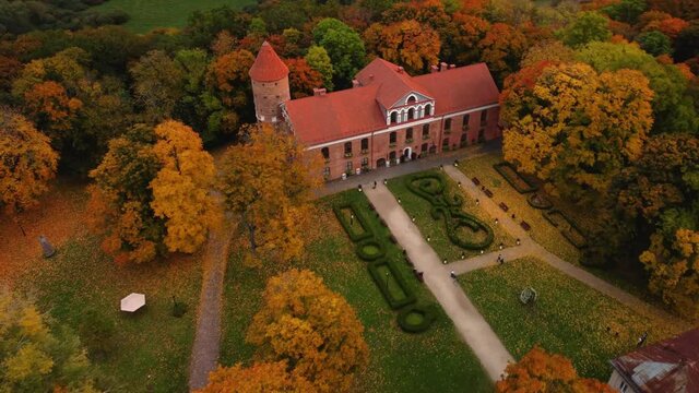 An aerial view of Raudondvaris castle and colorful autumn landscape, Lithuania near Kaunas