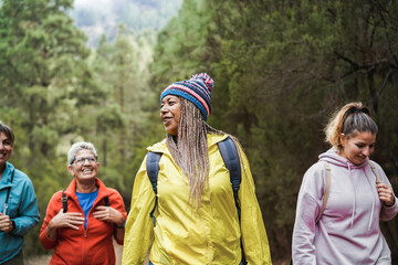 Multi generational women having fun during trekking day in tothe woods - Travel concept - Focus on...