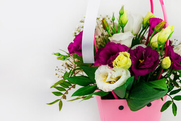 Beautiful white Eustoma Gypsophila flowers bouquet in pink pastel basket light background. Floral gift blooming wallpaper, Womens Mothers day greeting card wedding invitation Festive banner copy space