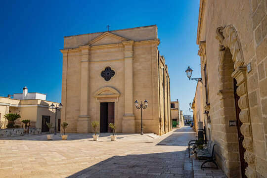 The small village of Acaya, Lecce, Salento, Puglia, Italy. The church of Santa Maria della Neve, in baroque, neoclassical and Romanesque style. The facade in the small square paved in flat stone.