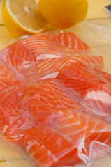 fresh salmon fillet in a vacuum package with lemon