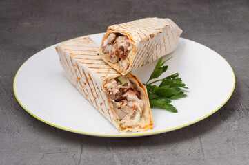 shawarma or doner kebab with chicken on a white plate