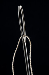 Sewing needle and thread, low key isolated