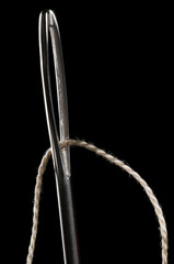 Sewing needle and thread, low key isolated