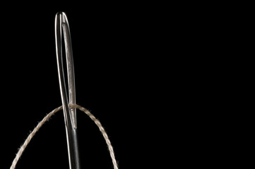 Sewing needle and thread, low key isolated