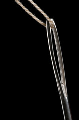 Sewing needle and thread, low key isolated