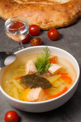 fish soup with salmon, potatoes in a white bowl