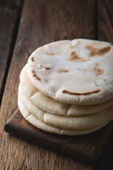 Fresh pita bread on a wooden table