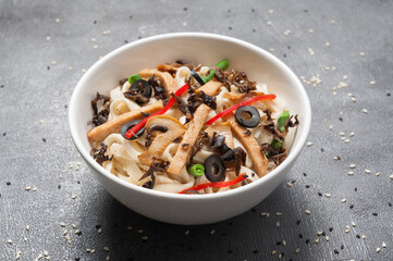 udon with chicken, vegetables and mushrooms. japanese cuisine