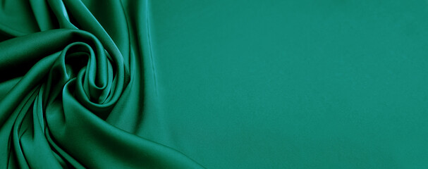 Green silk fabric as background, top view with space for text. Banner design