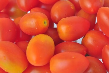 Delicious fresh cherry tomatoes on the background