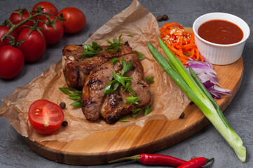 pork kebab on the bone with carrots and tomato sauce