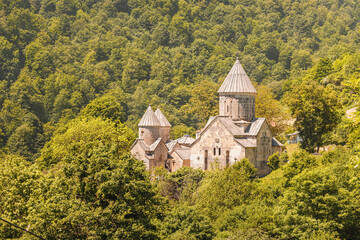 Obraz premium Armenian Haghartsin Monastery (founded in the 11th century) among lush forest and mountains of Dilijan national park