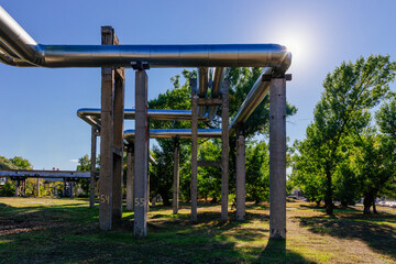 Steel pipelines outgoing from the plant at sunny day